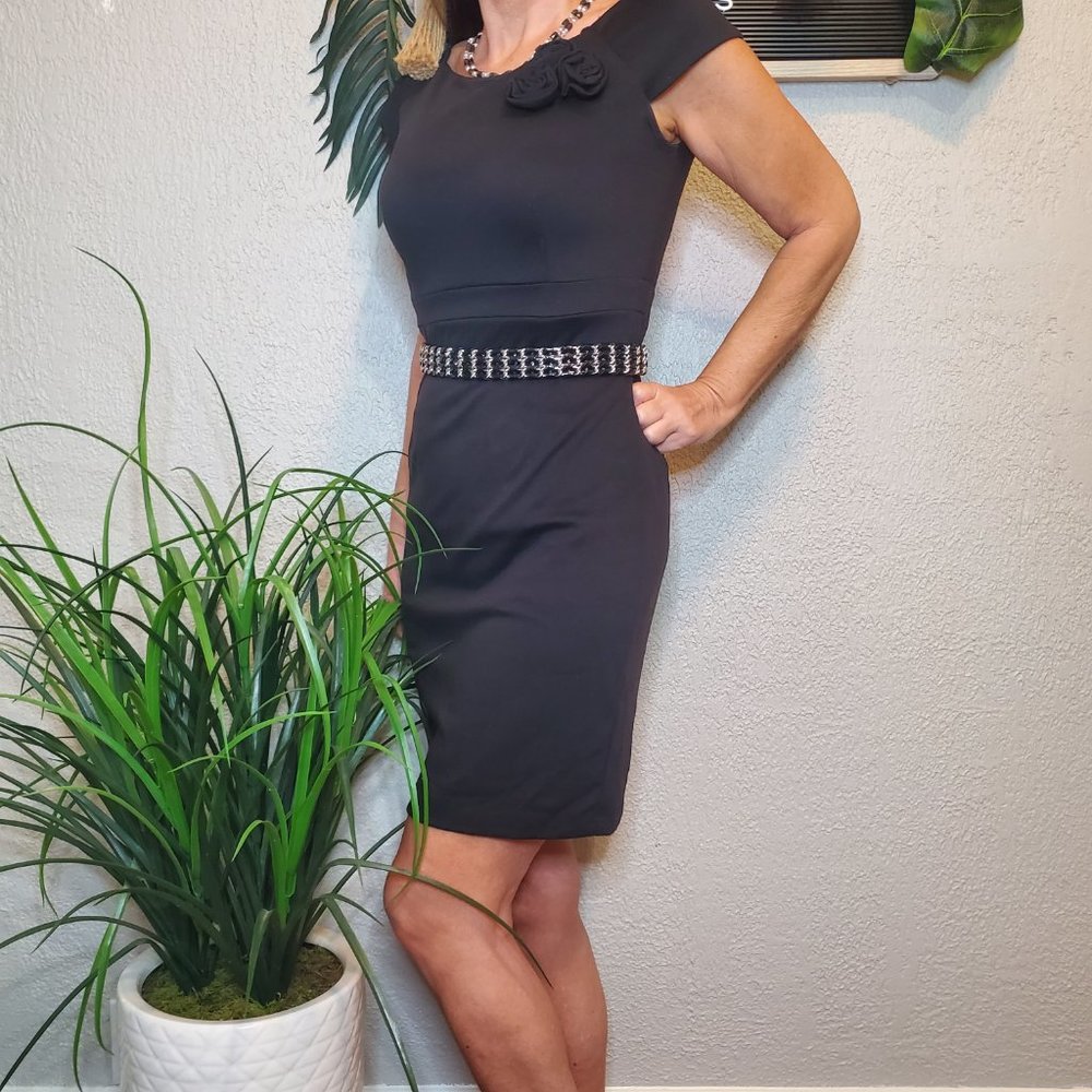 B. Smart I Black Sheath Dress with Rosette Detailing. Scoop neck sleevel…